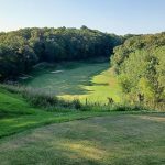 Panoramic view of a lush green golf course at Missouri Bluffs Golf Club. Smooth