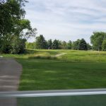 Panoramic view of a lush green golf course at Moccasin Creek Country Club. Smooth