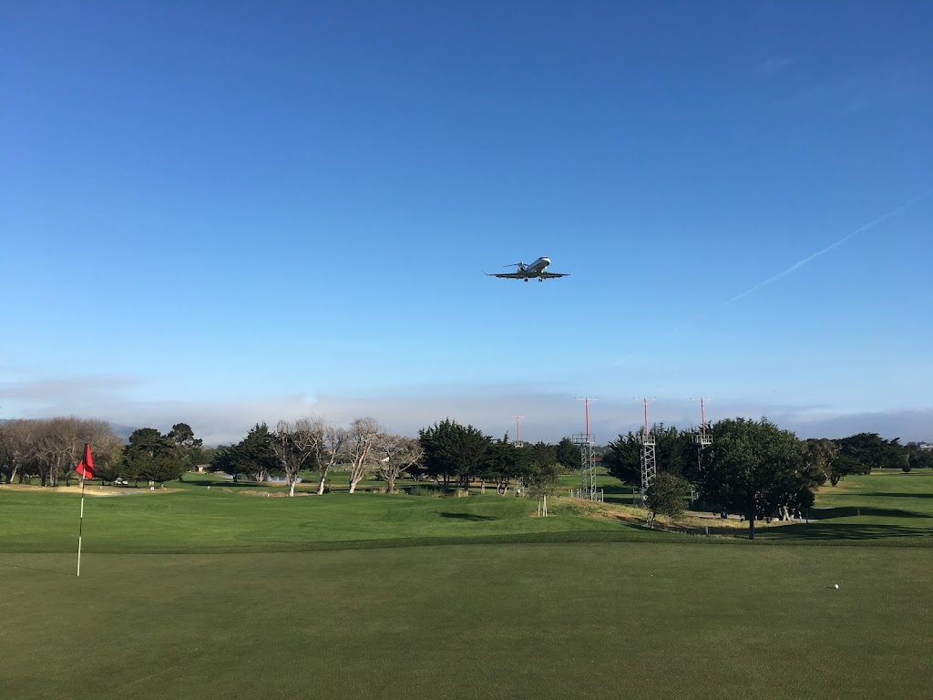 Panoramic view of a lush green golf course at Monterey Pines Golf Club. Smooth