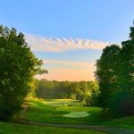 Panoramic view of a lush green golf course at Moose Ridge Golf Course. Smooth