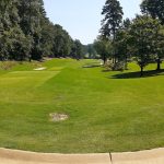 Panoramic view of a lush green golf course at Mountain Brook Club. Smooth