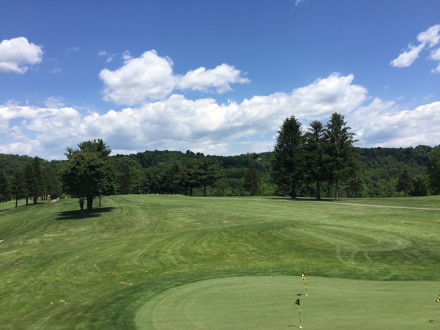 Panoramic view of a lush green golf course at Mountaineer's Woodview Golf Course. Smooth