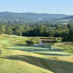 Panoramic view of a lush green golf course at Musket Ridge Golf Club. Smooth