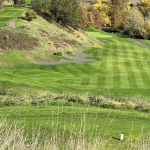 Panoramic view of a lush green golf course at Myrtle Creek Golf Club. Smooth