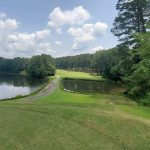 Panoramic view of a lush green golf course at Mystery Valley Golf Course. Smooth