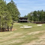 Panoramic view of a lush green golf course at Mystic Creek Golf Club. Smooth