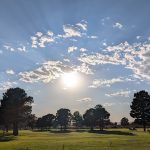 Panoramic view of a lush green golf course at NMSU Golf Course & The Player's Grill Restaurant. Smooth