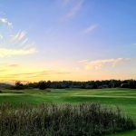 Panoramic view of a lush green golf course at Nonesuch River Golf Club. Smooth