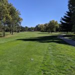 Panoramic view of a lush green golf course at Norfolk Country Club. Smooth