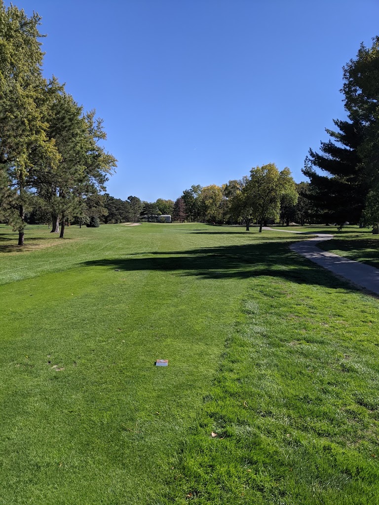 Panoramic view of a lush green golf course at Norfolk Country Club. Smooth