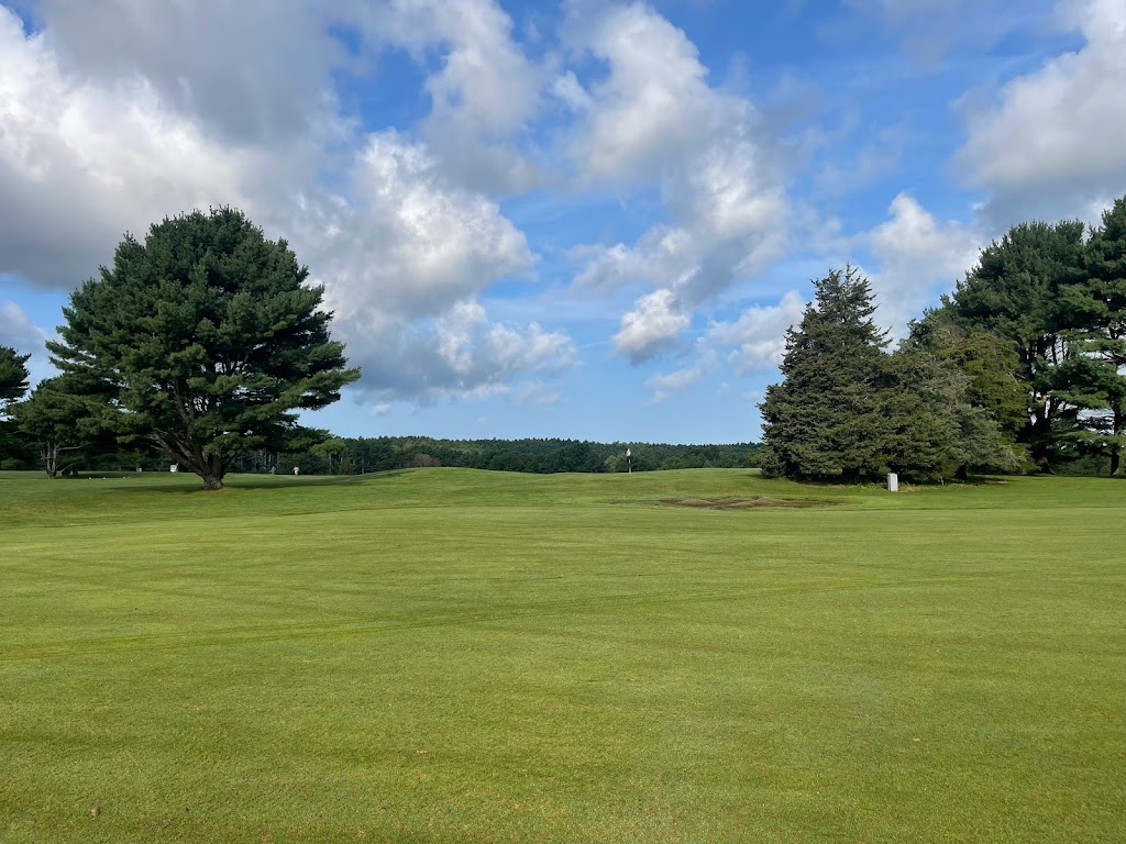 Panoramic view of a lush green golf course at North Hill Country Club. Smooth