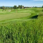 Panoramic view of a lush green golf course at Northern Pines-North Kalispell Golf Club. Smooth