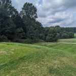 Panoramic view of a lush green golf course at Northport Golf Course. Smooth