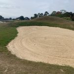 Panoramic view of a lush green golf course at Oak Harbor Golf Club. Smooth