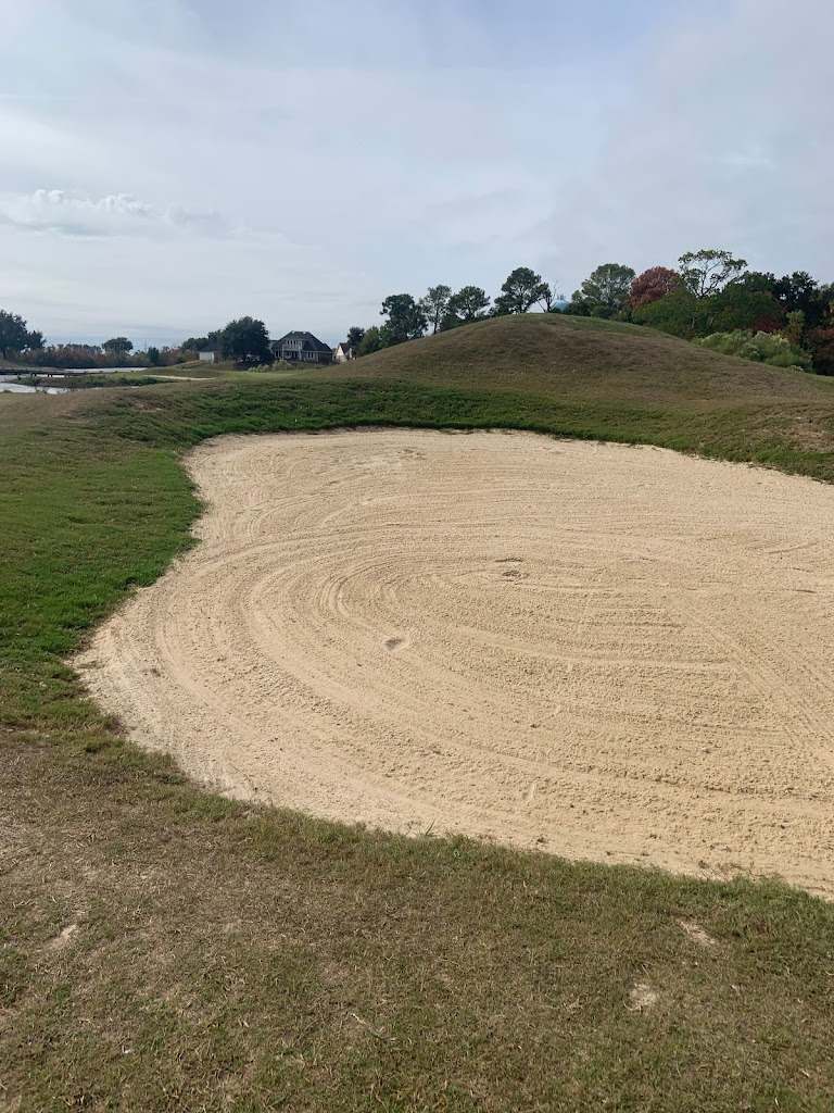 Panoramic view of a lush green golf course at Oak Harbor Golf Club. Smooth