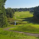 Panoramic view of a lush green golf course at Oak Valley Golf Club. Smooth