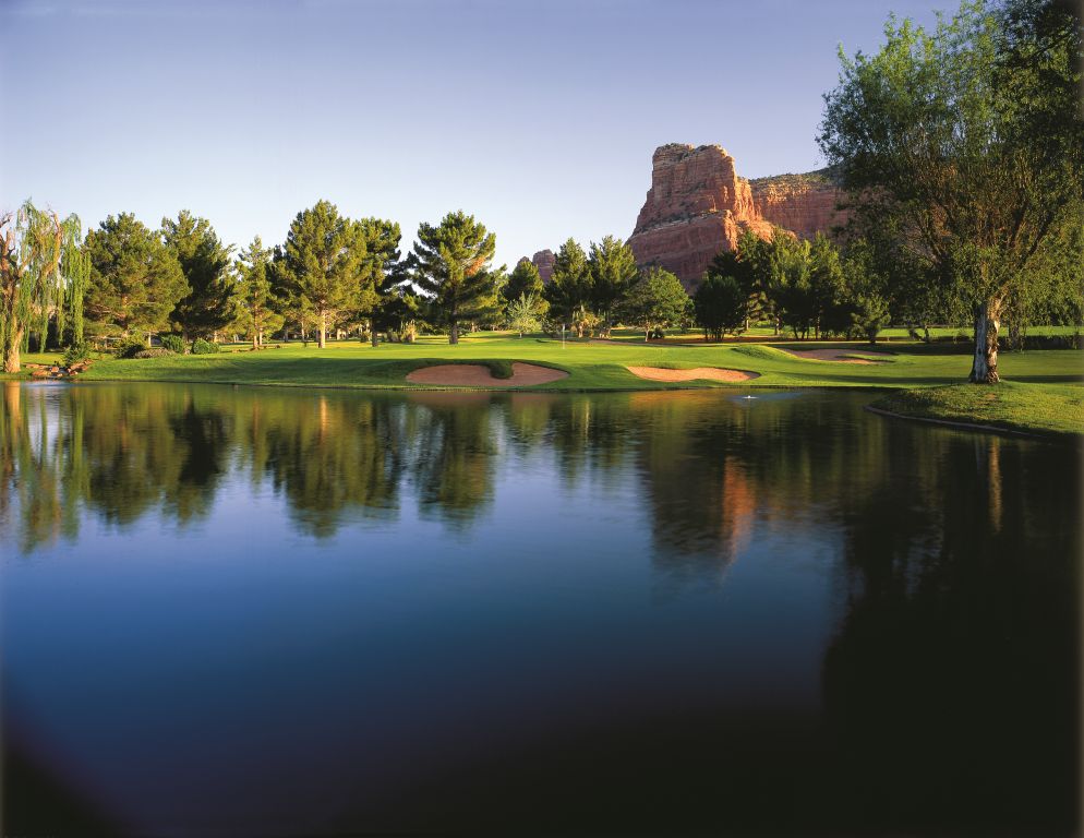 Panoramic view of a lush green golf course at Oakcreek Country Club. Smooth