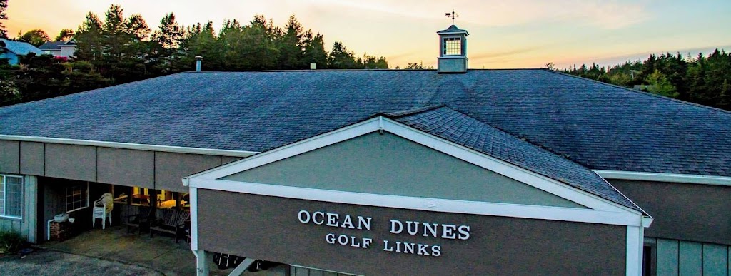 Panoramic view of a lush green golf course at Ocean Dunes Golf Links. Smooth