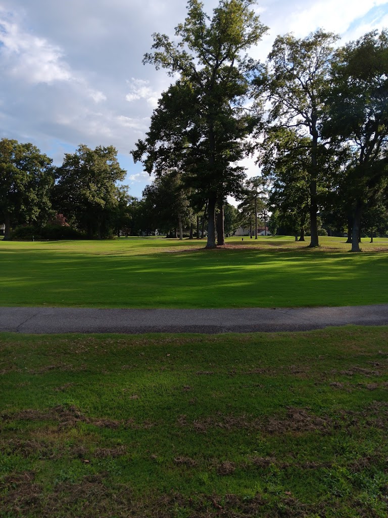 Panoramic view of a lush green golf course at Ocean View Golf Course. Smooth