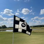 Panoramic view of a lush green golf course at Oeste Ranch Golf Course. Smooth