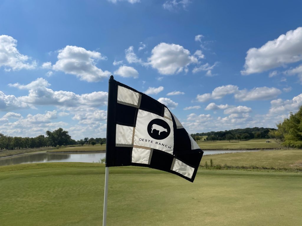 Panoramic view of a lush green golf course at Oeste Ranch Golf Course. Smooth