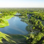 Panoramic view of a lush green golf course at Ol' Colony Golf Complex. Smooth