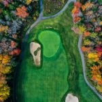 Panoramic view of a lush green golf course at Old Marsh Country Club. Smooth