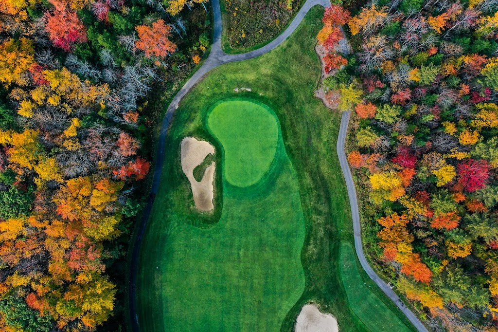 Panoramic view of a lush green golf course at Old Marsh Country Club. Smooth