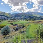 Panoramic view of a lush green golf course at Old Works Golf Course. Smooth