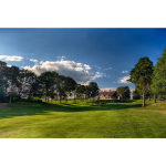 Panoramic view of a lush green golf course at Olde Barnstable Fairgrounds Golf Course. Smooth