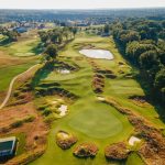 Panoramic view of a lush green golf course at Olde Stone BG. Smooth