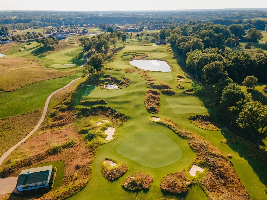 Panoramic view of a lush green golf course at Olde Stone BG. Smooth