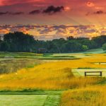 Panoramic view of a lush green golf course at Olympic Hills Golf Club. Smooth