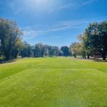 Panoramic view of a lush green golf course at Orchard Hills Golf Course. Smooth