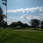 Panoramic view of a lush green golf course at Ortonville Municipal Golf Course. Smooth