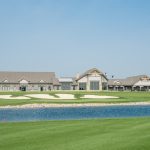 Panoramic view of a lush green golf course at Oxbow Country Club. Smooth