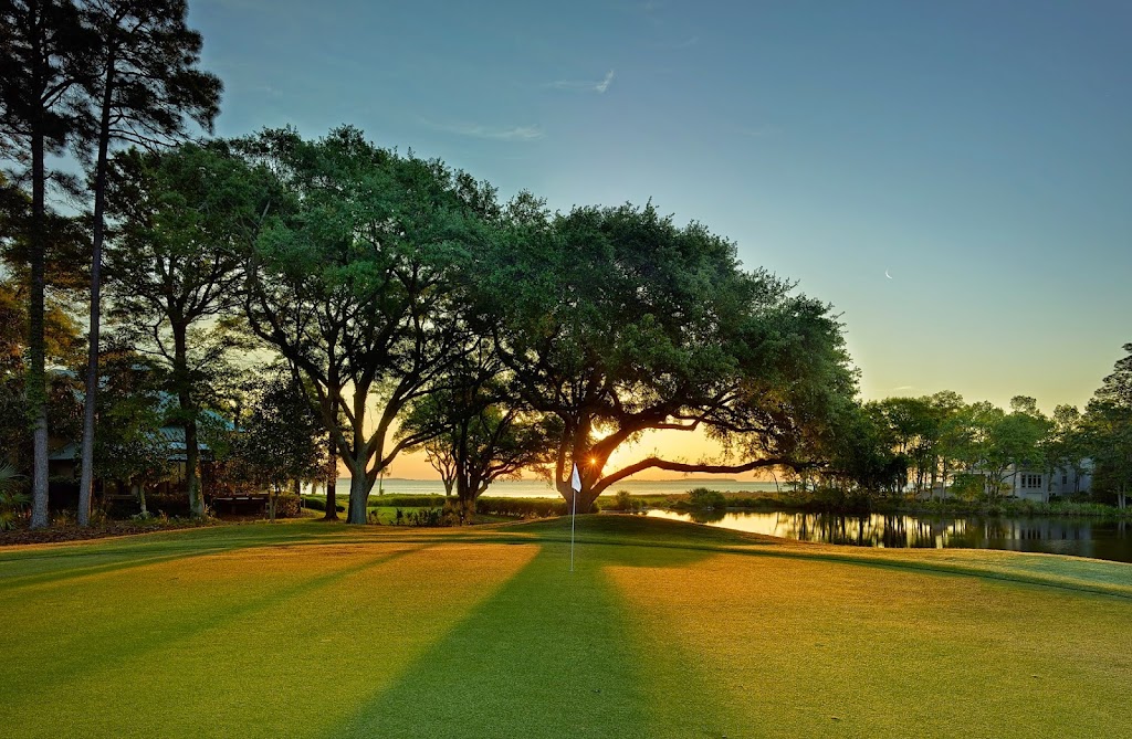 Panoramic view of a lush green golf course at Oyster Reef Golf Club. Smooth