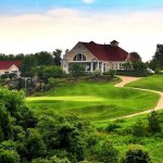 Panoramic view of a lush green golf course at PB Dye Golf Club. Smooth