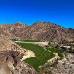 Panoramic view of a lush green golf course at PGA WEST Pete Dye Mountain Course. Smooth