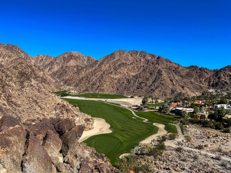 Panoramic view of a lush green golf course at PGA WEST Pete Dye Mountain Course. Smooth