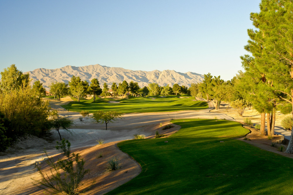 Panoramic view of a lush green golf course at Painted Desert Golf Club. Smooth