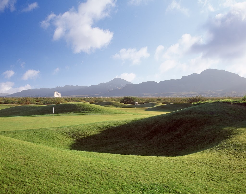 Panoramic view of a lush green golf course at Painted Dunes Desert Golf Course. Smooth