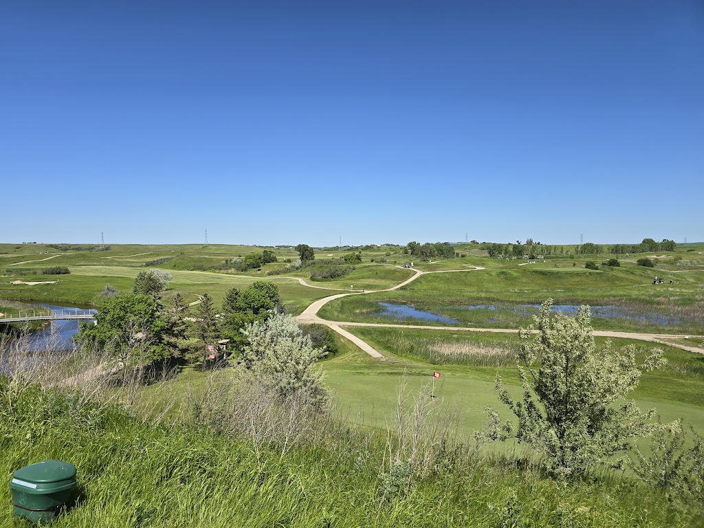 Panoramic view of a lush green golf course at Painted Woods. Smooth