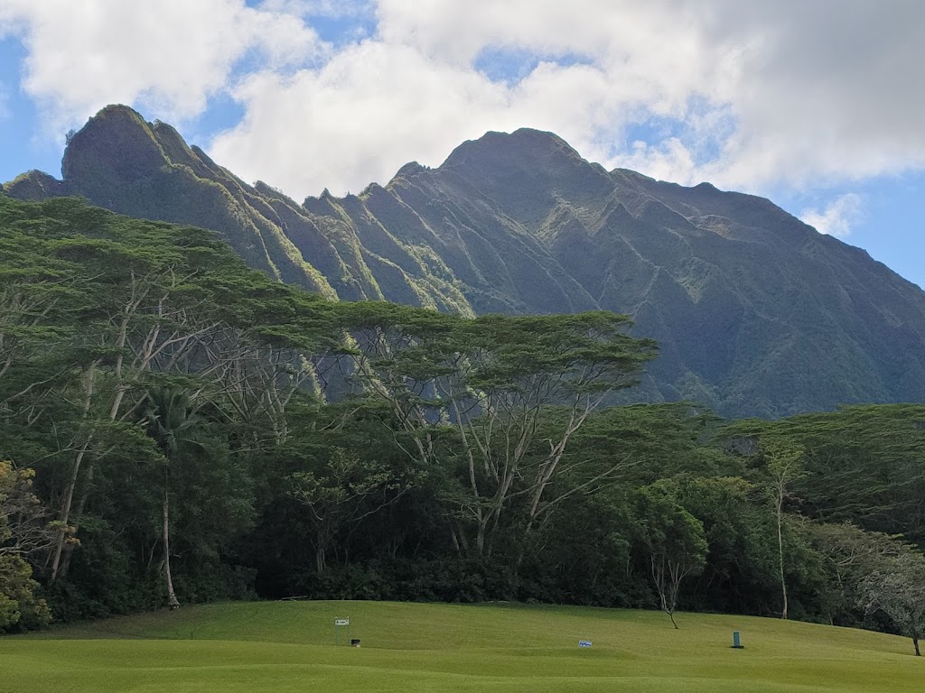 Panoramic view of a lush green golf course at Pali Golf Course. Smooth