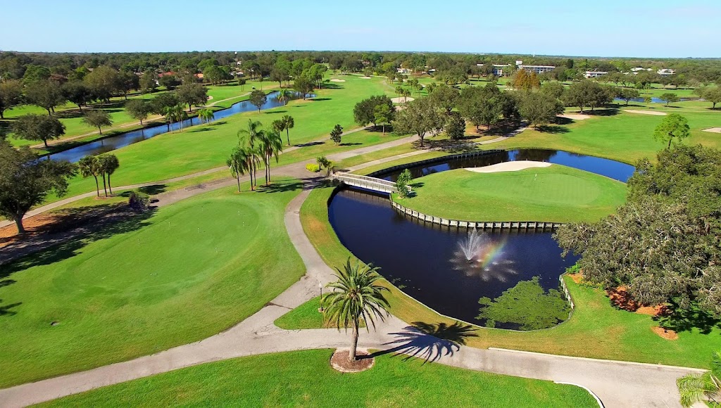 Panoramic view of a lush green golf course at Palm Aire Country Club. Smooth