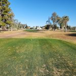 Panoramic view of a lush green golf course at Palo Verde Golf Course. Smooth