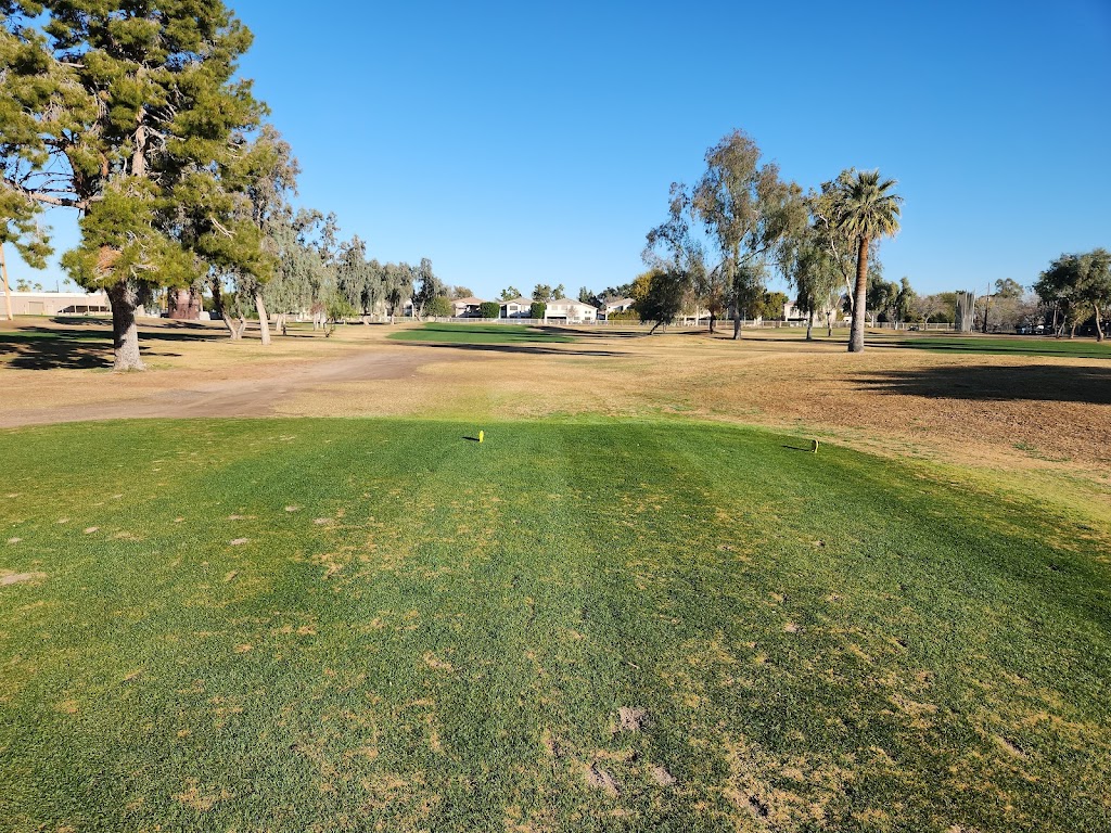 Panoramic view of a lush green golf course at Palo Verde Golf Course. Smooth