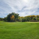 Panoramic view of a lush green golf course at Paradise Golf Course. Smooth