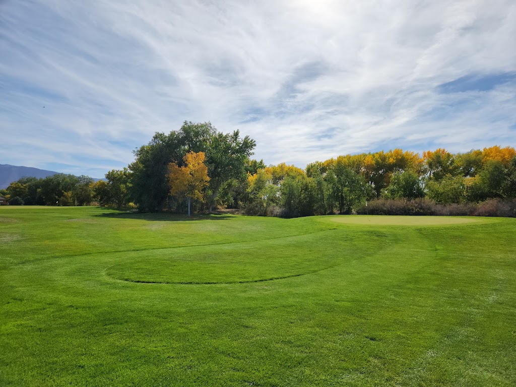 Panoramic view of a lush green golf course at Paradise Golf Course. Smooth