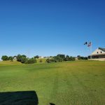 Panoramic view of a lush green golf course at Patriot Hills Golf Club. Smooth